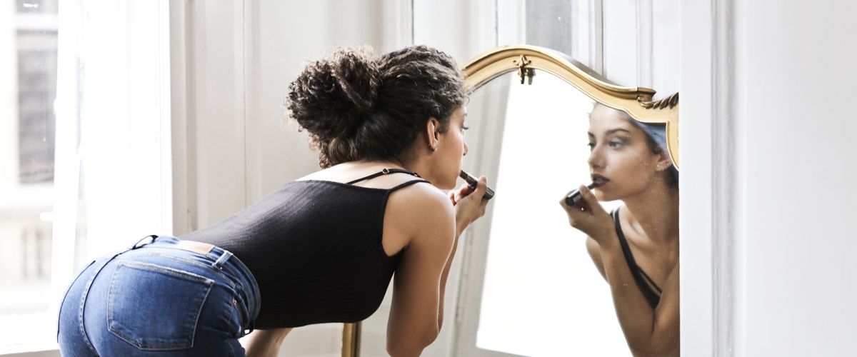 Woman sitting quietly by a window — nervous system regulation and emotional healing